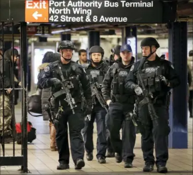 ?? AP FILE PHOTO ?? Police officers patrol Apassagewa­y connecting New York City’s Port Authority bus terminal and the Times Square subway station Dec. 12, a day after a would-be suicide bomber’s rush-hour blast failed to cause the bloodshed he intended.