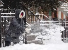  ?? PAT NABONG/SUN-TIMES ?? Daisy Gabriel shovels snow from her sidewalk in the Little Village neighborho­od Saturday afternoon.