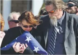  ??  ?? Melissa and John Carrigan, parents of Park County Cpl. Nate Carrigan, grieve as their son’s casket leaves Faith Bible Chapel in Arvada on Monday. Kathryn Scott Osler, The Denver Post