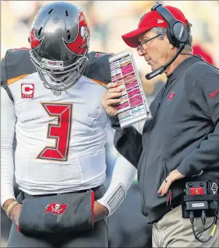  ?? AP PHOTO ?? In this Dec. 3 file photo, Tampa Bay Buccaneers head coach Dirk Koetter talks to quarterbac­k Jameis Winston during the second half of an NFL game against the Green Bay Packers in Green Bay, Wis.