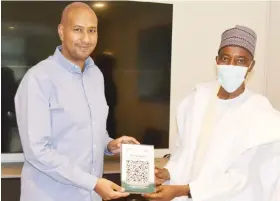  ??  ?? From right: Managing Director/CEO of Jaiz Bank, Hassan Usman, presenting the newly launched NQR platform to the Managing Director of Fraser Suites, M.G Nasreddin in Abuja, yesterday