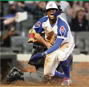  ?? Miamiheral­d.com/sports
TODD KIRKLAND Getty Images ?? The Braves’ young All-Star Ronald Acuna Jr. reacts after scoring on a shallow fly in the third inning against the Marlins on Monday at Truist Park. For game coverage, go to