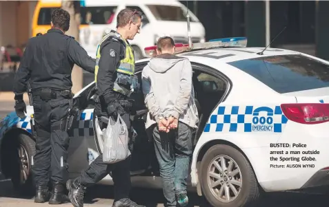  ?? Picture: ALISON WYND ?? BUSTED: Police arrest a man outside the Sporting Globe.