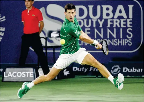  ?? Kamal Kassim / Gulf Today ?? ↑
Novak Djokovic returns the ball to Malek Jaziri (unseen) during their Dubai Duty Free Tennis Championsh­ips match on Monday.