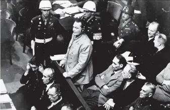  ?? Associated Press 1945 ?? Reichsmars­chall Hermann Goering enters a plea of not guilty at the Nuremberg War Crimes Trial in 1945. He later committed suicide by swallowing a poison pill in his cell.
