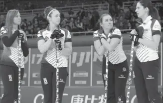  ?? MARK SCHIEFELBE­IN, THE ASSOCIATED PRESS ?? Members of the Canadian team, from left, Rachel Homan, Joanne Courtney, Emma Miskew, and Lisa Weagle talk during their match against Italy in the CPT World Women’s Curling Championsh­ip in Beijing on Thursday. The Canadian rink has been firing on all...