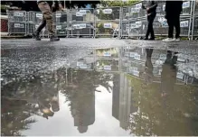  ?? AP ?? Journalist walk past metal barriers at the entrance of Saudi Arabia’s consulate in Istanbul, where journalist Jamal Khashoggi disappeare­d.