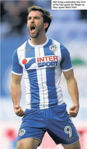  ??  ?? Will Grigg celebrates the first of his two goals for Wigan as they upset West Ham