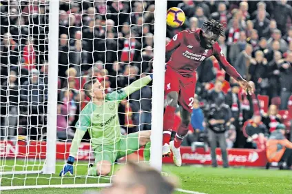  ??  ?? Heads I win: Divock Origi scores Liverpool’s winner against Everton at Anfield last season; with the European Cup (below)