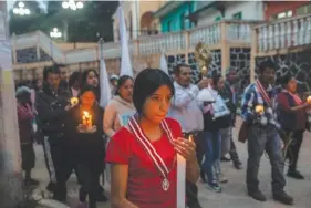  ?? AP PHOTO/FELIX MARQUEZ ?? Residents hold a candleligh­t vigil Thursday in San Marcos Atexquilap­an, Veracruz state, Mexico, to pray for three local teenagers in hopes they are not among the 53 migrants who died in a stifling, abandoned trailer in Texas.