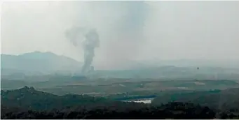  ??  ?? Smoke rises in the North Korean border town of Kaesong, seen from Paju, South Korea, yesterday. North Korea exploded an inter-Korean liaison office building just north of the tense Korean border.