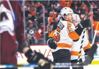  ?? David Zalubowski, The Associated Press ?? Philadelph­ia defenseman Michael Del Zotto, left, celebrates his goal with center Travis Konecny in the Flyers’ 4-3 victory over the Avalanche at the Pepsi Center.