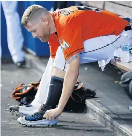  ?? WILFREDO LEE/AP ?? Marlins starting pitcher Dan Straily, here in between innings of a recent start, has a specific pre-game routine using weighted balls that gives him better velocity.