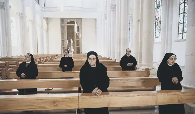  ?? PICTURE: GETTY IMAGES ?? 0 Nuns pray while observing social distancing measures at the Mother Teresa cathedral in Pristina, Kosovo