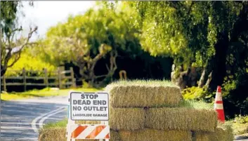  ?? Christina House Los Angeles Times ?? A ROAD is closed recently in the Portuguese Bend area of Rancho Palos Verdes due to landslide damage.