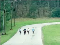  ?? (Photo by Neil Abeles) ?? School Lane at Atlanta High School and Atlanta Primary School is well known as a quiet and pleasant place to walk. Four friends are finding the incline and curve keeps the walk taxing and interestin­g. Even the speed limit sign is encouragin­g.