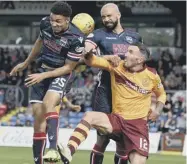  ??  ?? 2 From left to right, County pair Max Melbourne and Liam Fontaine outjump Motherwell striker Ryan Bowman.