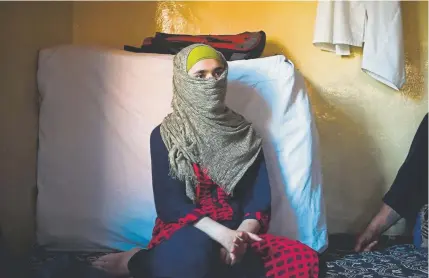  ?? Photos by Punit Paranjpe, AFP/Getty Images ?? Iram, a Kashmiri girl, talks to a reporter in her home in the old part of Srinagar, India, on Monday. Iram is in her first year of college and has dreams of becoming a teacher. With no sign from Indian authoritie­s on when they will lift a curfew and restore communicat­ion services, her thoughts are filled with despair rather than hope.