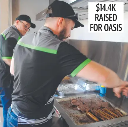  ??  ?? Lamberts Fresh Produce held sausage sizzles to raise money for The Oasis Townsville. Picture: Supplied