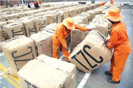  ?? Picture: Believe Nyakudjara ?? Workers at Tian Ze Tobacco Company, sorting bales at the company’s premises in Harare recently. Tobacco contractin­g companies have been receiving significan­t number of bales compared to the auction system.