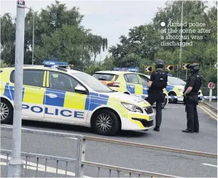  ??  ?? Armed police at the scene after a shotgun was discharged