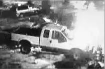  ??  ?? A frame of video surveillan­ce shows a truck owned by Eglinton Collison Centre burning after someone spread liquid over the pickup and torched it. Two other cars were also set ablaze.