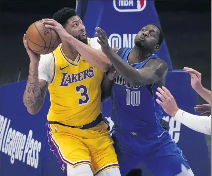  ?? PHOTOS BY TONY GUTIERREZ — THE ASSOCIATED PRESS ?? The Lakers’ Anthony Davis, who had four points on 2-of-10 shooting, works to get a shot against the Mavericks’ Dorian Finney-Smith.