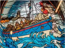  ??  ?? A stained glass window in the lifeboat station depicts a dramatic rescue attempt in stormy seas by Henry Blogg and crew.