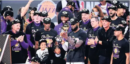  ?? Picture: Getty ?? LeBron James holds the trophy as the LA Lakers celebrate winning the NBA title