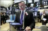  ?? RICHARD DREW — THE ASSOCIATED PRESS ?? Trader Neil Catania works on the floor of the New York Stock Exchange, Wednesday. Technology companies led U.S. stocks higher Wednesday in a broad rally that helped nudge the Dow Jones industrial average to a new high.