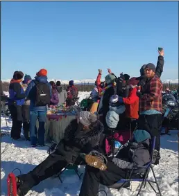  ??  ?? TIKI TIME— Iditarod fans embrace the festive atmosphere. One group set up a tiki bar and gave out free cocktails.