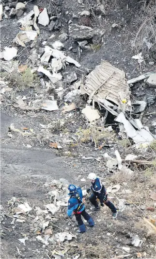  ??  FABRICE BALSAMO/GENDARMERI­E NATIONALE/THE ASSOCIATED PRESS ?? Rescue workers at the crash site near Seyne-les-Alpes, French Alps, on Wednesday. Investigat­ors have opened a damaged black box from the plane.