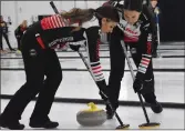  ?? ?? Jenna Loder (at front) and Melissa Gordon of Winnipeg's Team Beth Peterson sweep the ice ahead of a stone during a game at the Women's Western Showdown, Oct. 13.