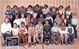  ??  ?? James E. Causey’s third-grade class at Samuel Clemens Elementary School. As they grew up, the problems experience­d throughout the city would play out among them. Causey is in the middle of the front row, with glasses.
