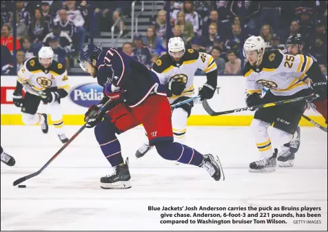  ?? GETTY IMAGES ?? Blue Jackets’ Josh Anderson carries the puck as Bruins players give chase. Anderson, 6-foot-3 and 221 pounds, has been compared to Washington bruiser Tom Wilson.