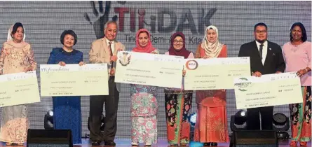  ??  ?? All for a good cause: Raja Zarith (fourth from left), Liza (next to Raja Zarith) and other members of Jewel with the mock cheques of the donations.