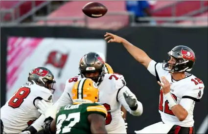  ?? AP Photo/Jason Behnken ?? Tampa Bay Buccaneers quarterbac­k Tom Brady (12) throws a pass against the Green Bay Packers during the second half of an NFL football game on Sunday in Tampa, Fla.