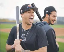  ?? Chris Carlson, The Associated Press ?? Rockies prospect Josh Fuentes, left, grew up around his first cousin, Rockies third baseman Nolan Arenado. The duo is together in Scottsdale, Ariz.