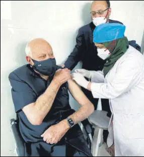  ?? AMAL KS/HT PHOTO; ANI ?? Clockwise from top left: Union minister Harsh Vardhan is administer­ed the vaccine in New Delhi; National Conference MP Farooq Abdullah takes his first dose of Covid-19 vaccine in Srinagar; Indian cricket team’s head coach Ravi Shastri receives the first dose of the Covid-19 vaccine in Ahmedabad, on Tuesday.