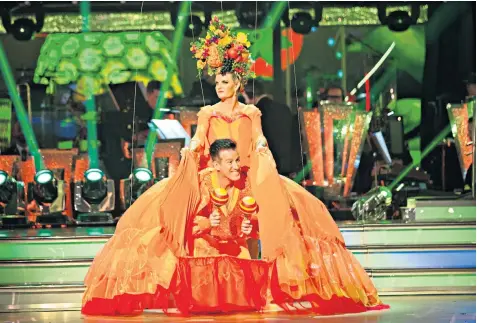  ??  ?? Anton Du Beke, the profession­al dancer, with Susannah Constantin­e, his partner, who wore a Carmen Miranda-style outfit for their first routine on this year’s Strictly Come Dancing