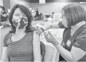  ?? JOSHUA EMERSON SMITH U-T ?? A teacher gets vaccinated at the Sharp Healthcare Vaccinatio­n Superstati­on in Chula Vista last month.