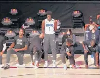  ?? CHARLES KING/ORLANDO SENTINEL ?? Magic forward Jonathan Isaac is the lone player to stand and not wear a Black Lives Matter T-shirt on Friday.