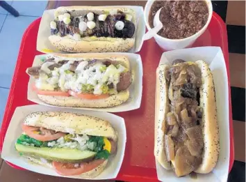  ?? MIKE MAYO/SOUTH FLORIDA SUN SENTINEL ?? Hotdog-Opolis in Boca Raton offers an assortment of creative hot dogs and exotic game sausages. It also offers a solid Chicago hot dog.