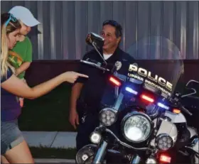  ??  ?? Guests got a close-up look at an Upper Providence Police motorcycle among others. The community was invited Wednesday to the first ever Royersford Emergency Services Night held outside the Royersford Fire Department.