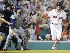  ?? Michael Dwyer ?? The Associated Press Red Sox right fielder Mookie Betts exults in front of Blue Jays catcher Russell Martin after hitting a grand slam during Boston’s 6-4 home victory Thursday.