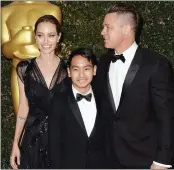  ??  ?? Angelina Jolie, Brad Pitt and their eldest child Maddox Jolie-Pitt at the Oscars.