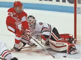  ?? STAFF PHOTO BY STUART CAHILL ?? TALLY HO! Boston University forward Clayton Keller sneaks the puck past Northeaste­rn goalie Ryan Ruck in a November game.