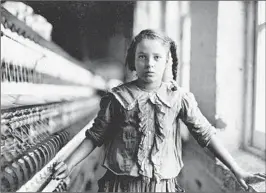  ?? LIBRARY OF CONGRESS PHOTOS ?? A young spinner in a North Carolina cotton manufactur­ing company poses for Lewis Hine.