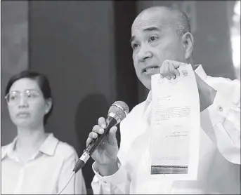  ?? BOY SANTOS ?? Lawyers Jojo Lacanilao and Josa Deinla show a copy of Chief Justice Maria Lourdes Sereno’s formal leave of absence during a press conference in Quezon City yesterday.