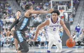  ?? Joe Buglewicz The Associated Press ?? Kentucky guard Sahvir Wheeler looks to drive on North Carolina guard Anthony Harris in the second half of the Wildcats’ 98-69 win Saturday at T-Mobile Arena.